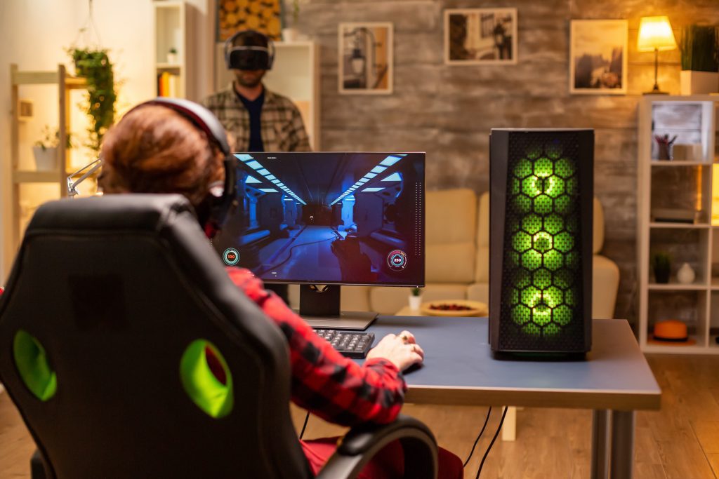 Professional video gamer female playing an online shooter game late night in the living room